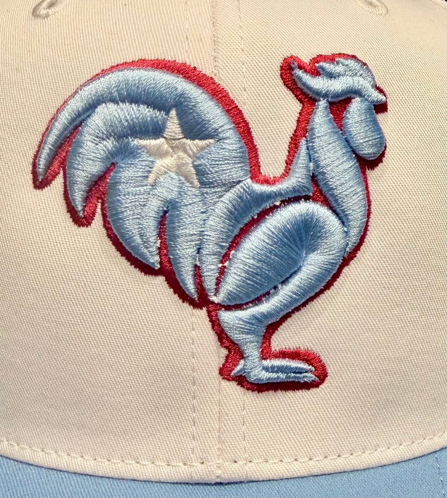White and Columbia blue Snapback. Columbia blue rooster, white star, red outline