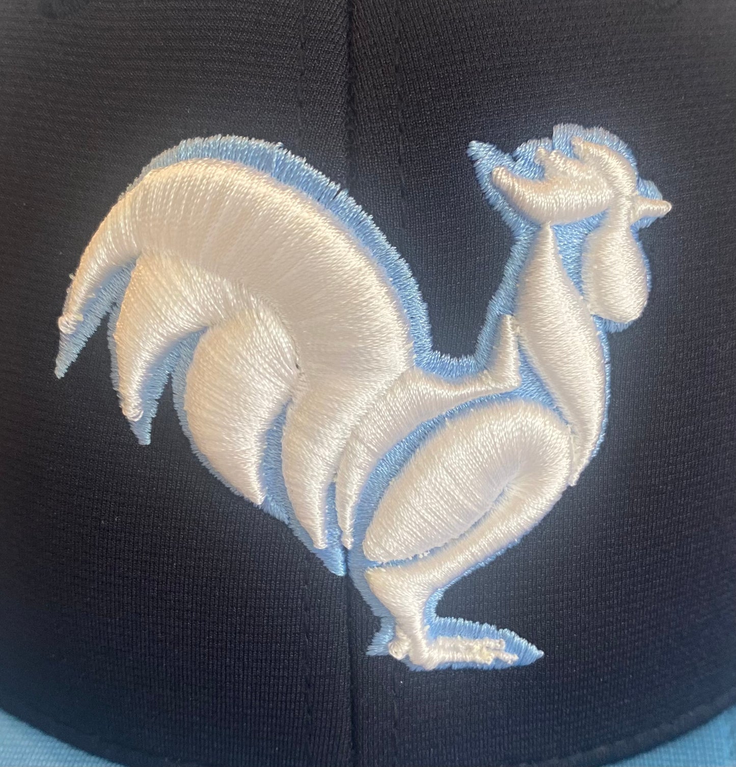 Navy with Carolina blue bill with solid white rooster with blue outline