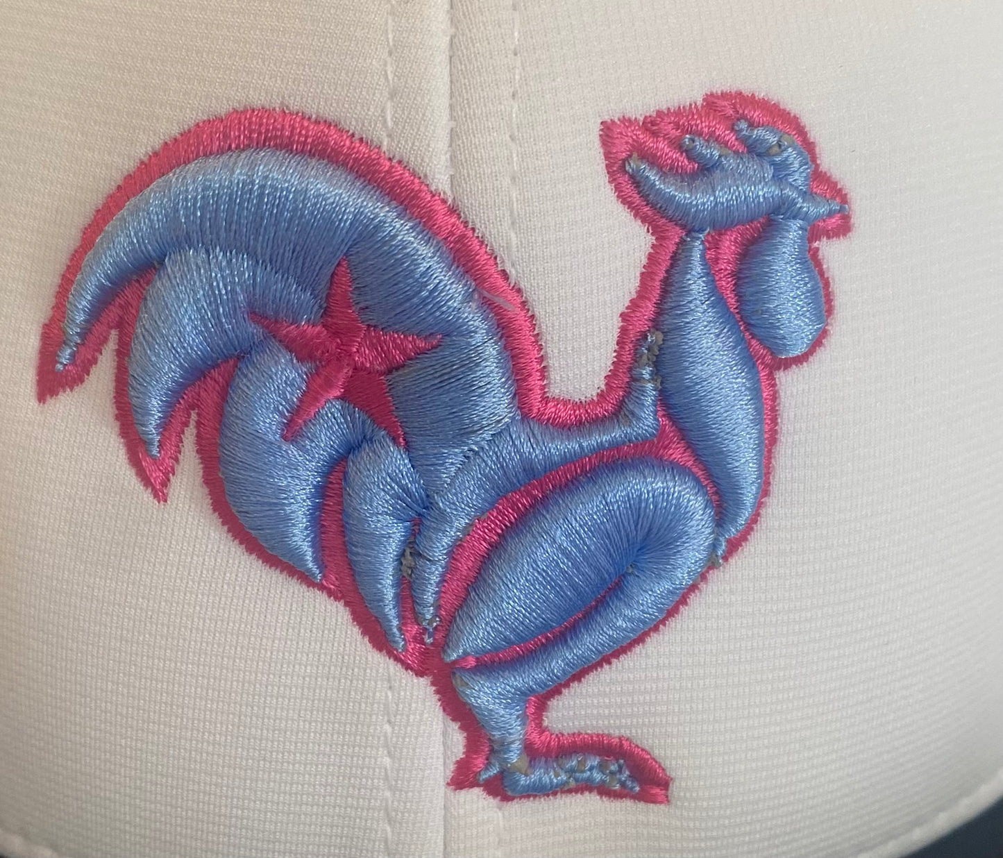 White hat, navy bill. Blue rooster with pink outline & star